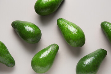 Fresh ripe avocados on grey background