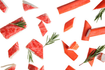 Cut tasty crab sticks and rosemary flying on white background © Pixel-Shot