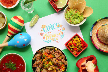 Traditional Mexican food, maracas and Cinco de Mayo greeting card on green background
