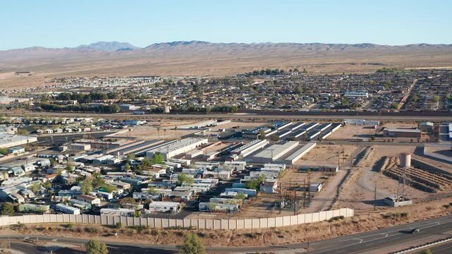 Aerial drone view of Barstow California residential homes and car traffic