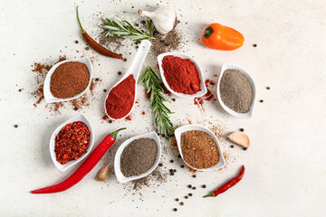 Composition with bowls of different fresh spices on light background