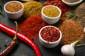 Composition with different aromatic spices on dark background
