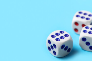 Dices with red and blue pips on blue background, closeup