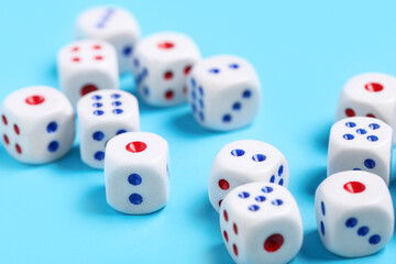Dices with red and blue pips on blue background, closeup