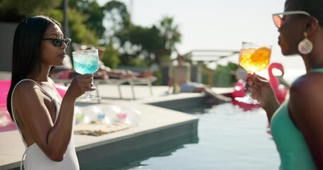 Women, friends and cheers with drink at pool for summer holiday, vacation or weekend at party. Female people, toast or cocktail with sunglasses or smile for good vibes or fun time at luxury resort