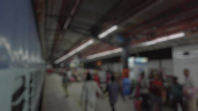 Bokeh view of night train departing from New Delhi railway station. Blurred background footage.