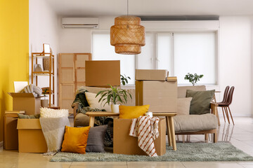 Furniture with cardboard boxes in room on moving day