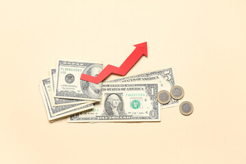 Money and arrow on beige background. Concept of rising price