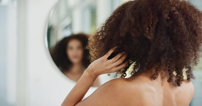 Mirror, check and woman with afro, haircare and back view of person, confidence and results of treatment. Natural beauty, glow and shine of hair, home and model with hairstyle from salon in apartment