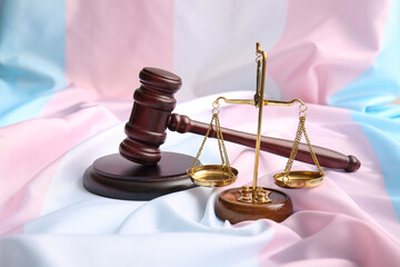 Scales of justice with judge gavel on transgender flag