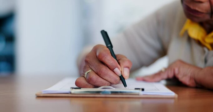Senior, woman and writing application for retirement, will or life insurance paperwork at table in home. Elderly, person or hands with pen, documents or title deed contract for legal policy in lounge