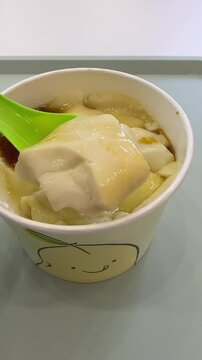 a bowl of gula melaka beancurd from Mr. Bean store at The Exchange TRX shopping mall. the iconic soybean store from Singapore. soya tofu with brown sugar syrup