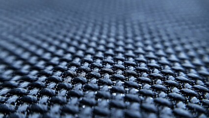 Fototapeta premium Close-up shot of dark blue woven fabric texture. Ideal for backgrounds, textile design, or industrial themes.