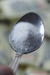 Silver spoon filled with sugar substitute , sweetener sugar