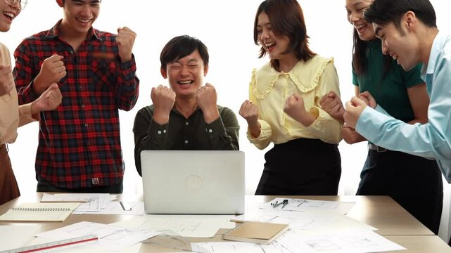 Architect and safety engineer celebrate success design building blueprint project on laptop with architectural document and measurement tool scatter around at modern office. Closeup. Delineation.