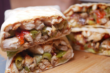 Delicious chicken and vegetable wrap served on a wooden board