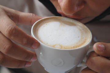 Enjoying a warm cup of coffee in a cozy setting