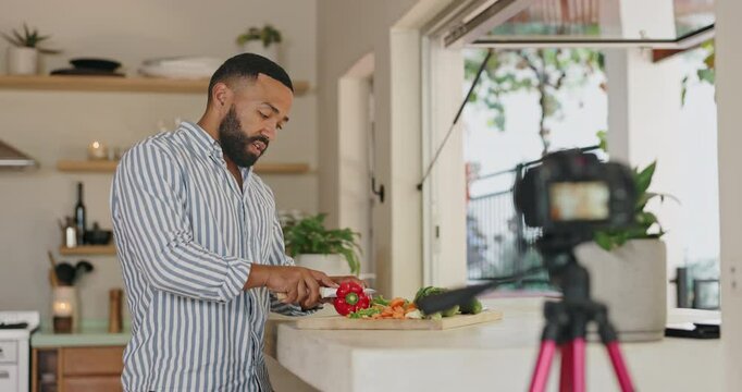 Man, cooking and live streaming in home kitchen for video, post or vlog for class, nutrition or diet with red pepper. Person, influencer or chef with vegetables, food or recording for social network
