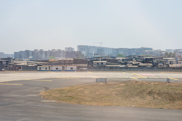 Naklejka premium India, Maharashtra, Mumbai, a view of a city skyline dharavi slum and tall buildings