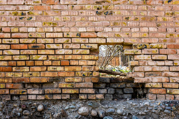 Old brick wall with hole, weathered texture, grunge background