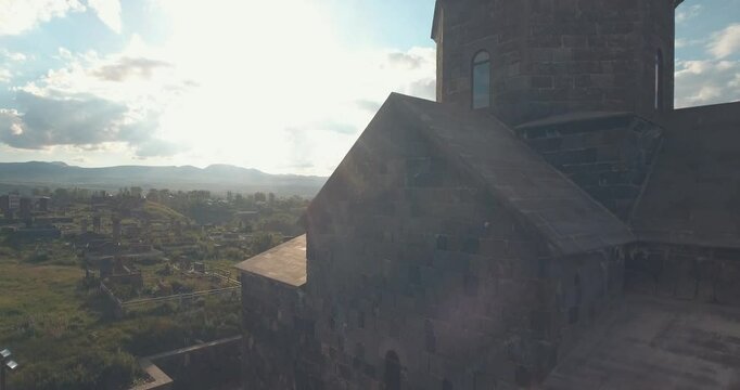 Ascending drone shot of Kotavank church in Nerkin Getashen village in Gegharkunik, Armenia at sunset