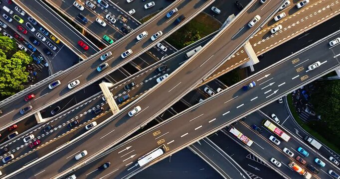 Aerial shot of a complex highway interchange and busy city traffic in the morning