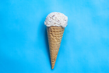 vanilla ice cream cone on blue background