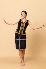 Beautiful Female Kadazandusun Native in traditional costume posing in plain background
