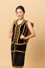 Beautiful Female Kadazandusun Native in traditional costume posing in plain background