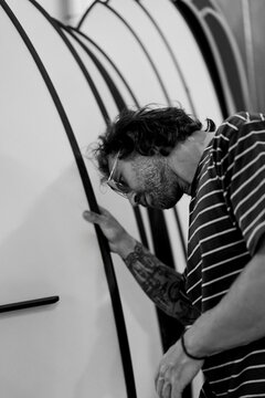 Man choosing a surfboard in a surfboard shop