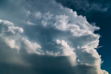 Large white thunderhead cloud in blue sky