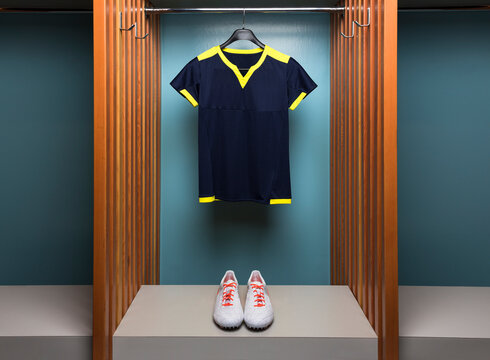 Blue soccer uniform and cleats in team locker room