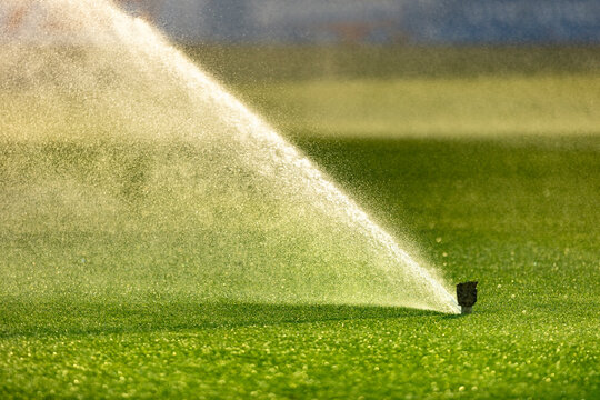 Automatic Lawn Sprinkler Watering Green Grass