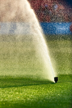 Automatic Lawn Sprinkler Watering Green Grass