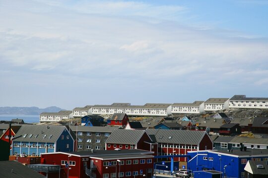 Traditional Multi coloured timber houses with a row of modern houses in the background, Nuuk, Sermersooq, Greenland, Kingdom of Denmark