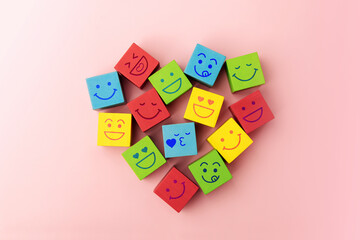 Love, Happy Community. Mind and mental Health Concepts. Group of Smiling Emoticon Diversity Face on Multi-colour Cube as Heart Shape. Table Top View