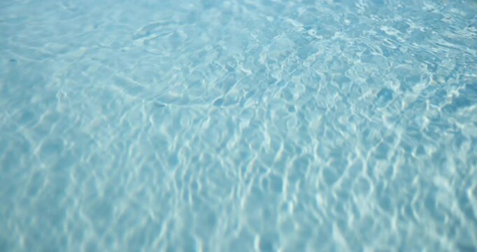 Background, ripples and space with clear water outdoor at hotel or resort for relax or mockup. Holiday, summer and vacation with swimming pool at lodge for accommodation or hospitality from above