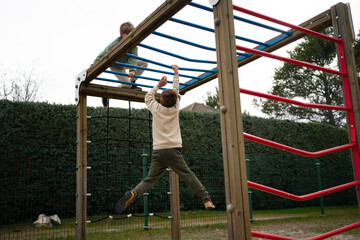 Children climbing monkey bars on playground structure in backyard