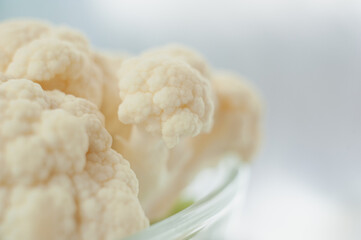 Cauliflower on a light background. Vegetables close-up. Macro photo.
