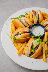 Tasty sandwiches arranged with golden fries and a side of creamy dip create a delightful dish