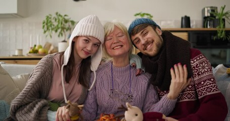 Family gathering indoors during winter, sharing cozy moments and handmade crafts in a warm, inviting home