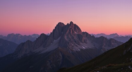 Majestic mountain peak at sunset against a colorful sky  