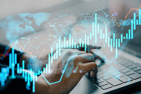 Businessperson analyzing global stock market data on laptop with futuristic financial graphs and world map overlay on light background concept.