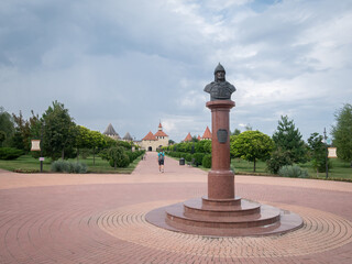 Historical square with warlord statue and medieval fortress in backdrop, Moldova, Europe