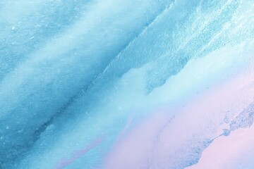 A dreamy, ethereal abstract image featuring a soft blend of pastel blue and pink hues. The texture is reminiscent of watercolor or clouds.
