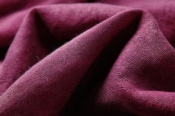 A close-up of the rich, deep burgundy fabric, capturing the intricate weave and natural texture of linen. The folds and creases add dimension, inviting you to imagine the soft.