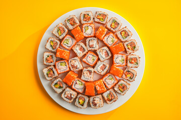  a chef in a restaurant prepares delicious Japanese sushi and rolls