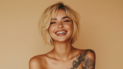 Smiling blond pretty happy girl beauty female generation z tattooed model with short blonde hair beautiful face healthy skin looking at camera laughing isolated at beige background. Aesthetic portrait