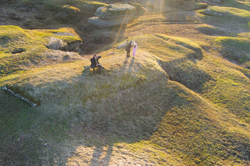 Young family relaxing in karst area on spring day, photo view from drone.
