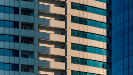 many windows and walls facade of a modern skyscraper without people